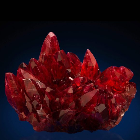 Rhodochrosite is what this picture is, with sharp dogtooth style crystals in a blood red color you would never believe