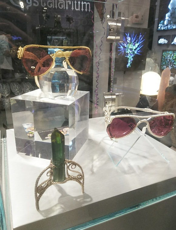 View of two sunglasses made with gem tourmaline slice lens and a custom wire base for a green tourmaline crystal