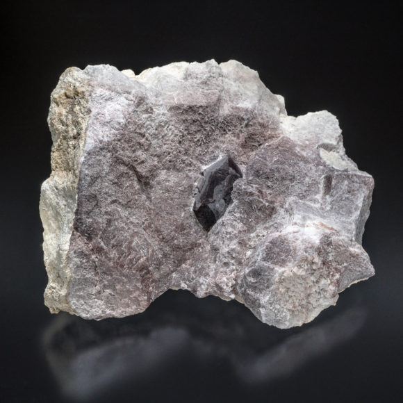 A Pecos Valley Diamond embedded in the host rock of massive gypsum. These crystals appear to take the color of the surrounding gypsum, though the crystals tend to universally be darker. Specimen is 15.2cm across; crystal length is 3.4cm.